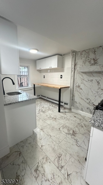 18 Irvine Turner Boulevard, Unit 2 Newark, NJ 07103 - Photo 4 of 11 a room with a sink and a stove