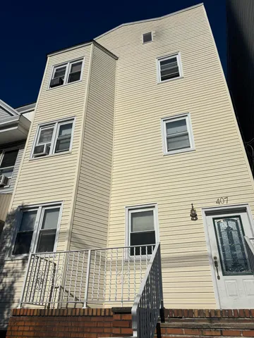 a view of a house with wooden deck