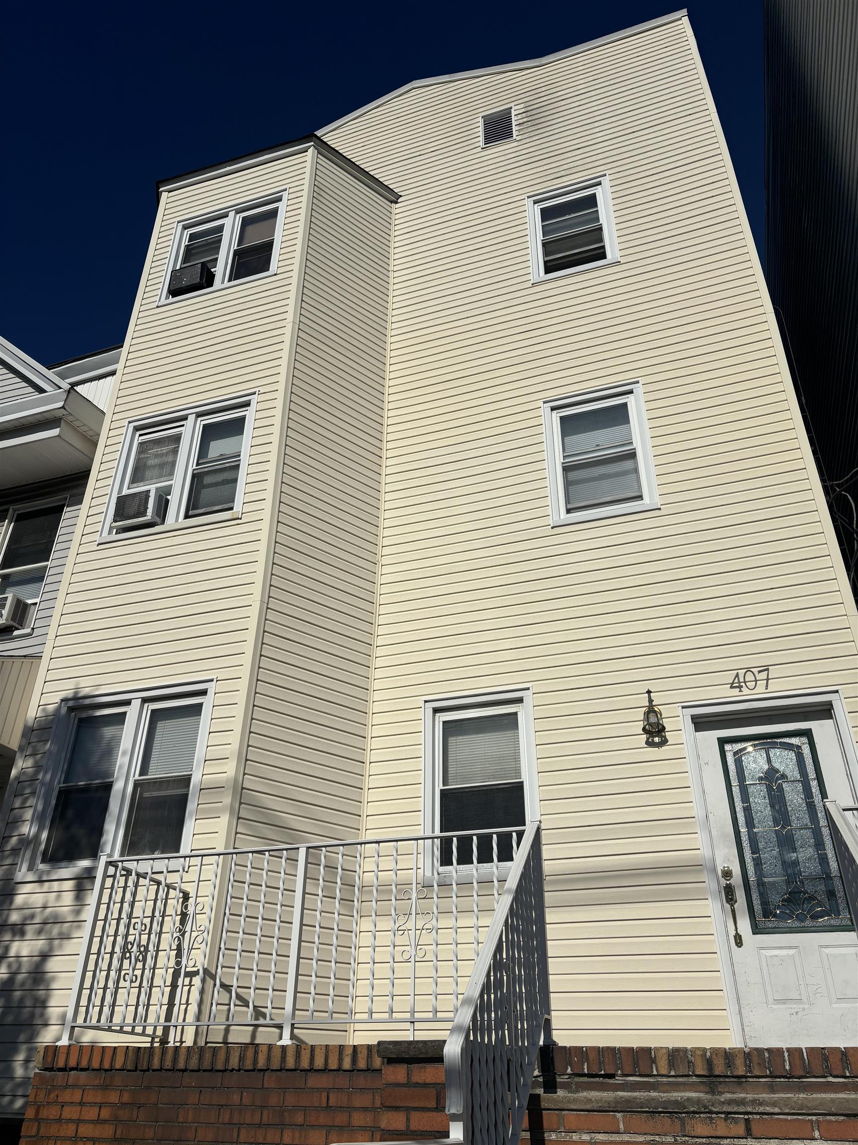 a view of a house with wooden deck