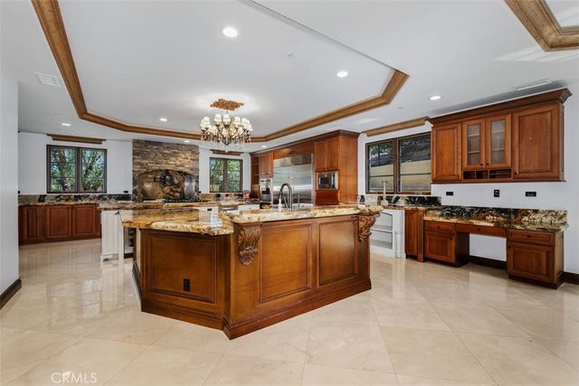 a kitchen with stainless steel appliances granite countertop a stove a sink dishwasher and a refrigerator