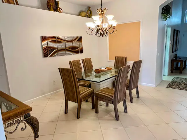 a dining room with furniture and chandelier