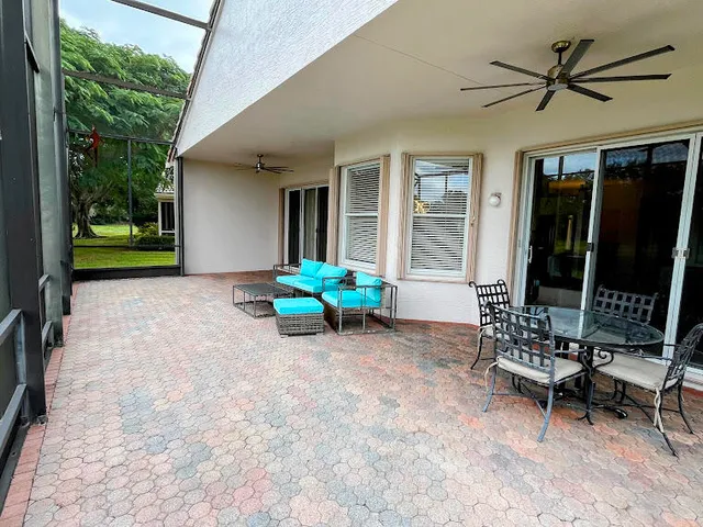a view of a house with backyard and porch