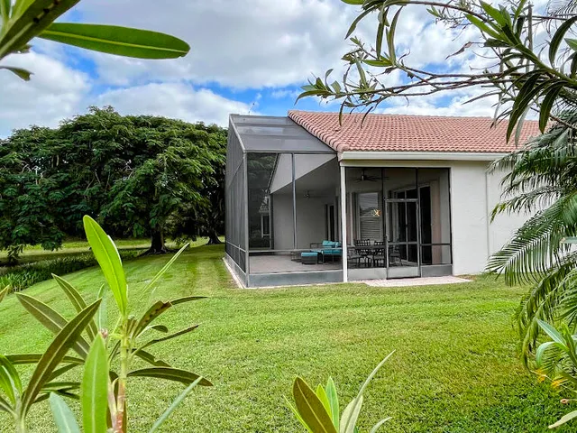 a view of a house with pool and a yard