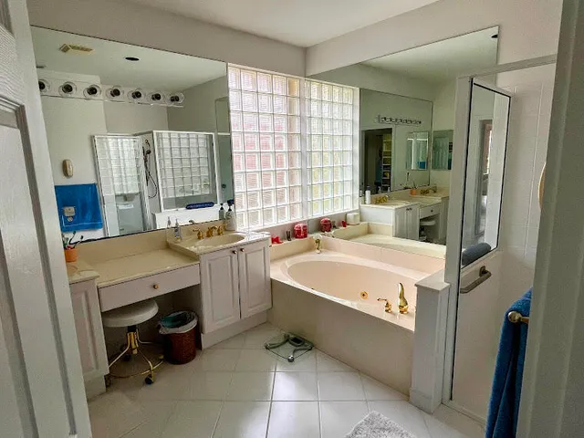 a view of washer and dryer with bathtub in a room