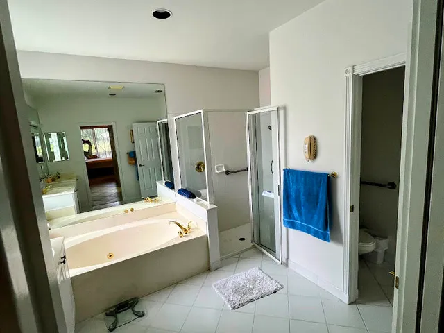 a large bathroom with a double vanity sink and mirror