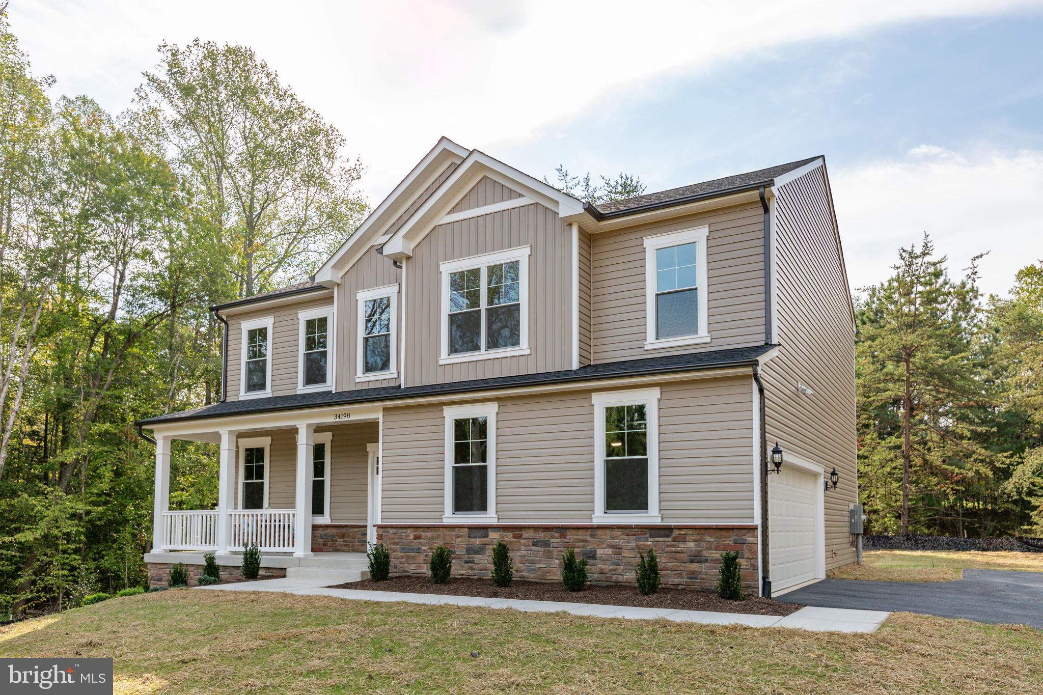 a front view of a house with yard and garage