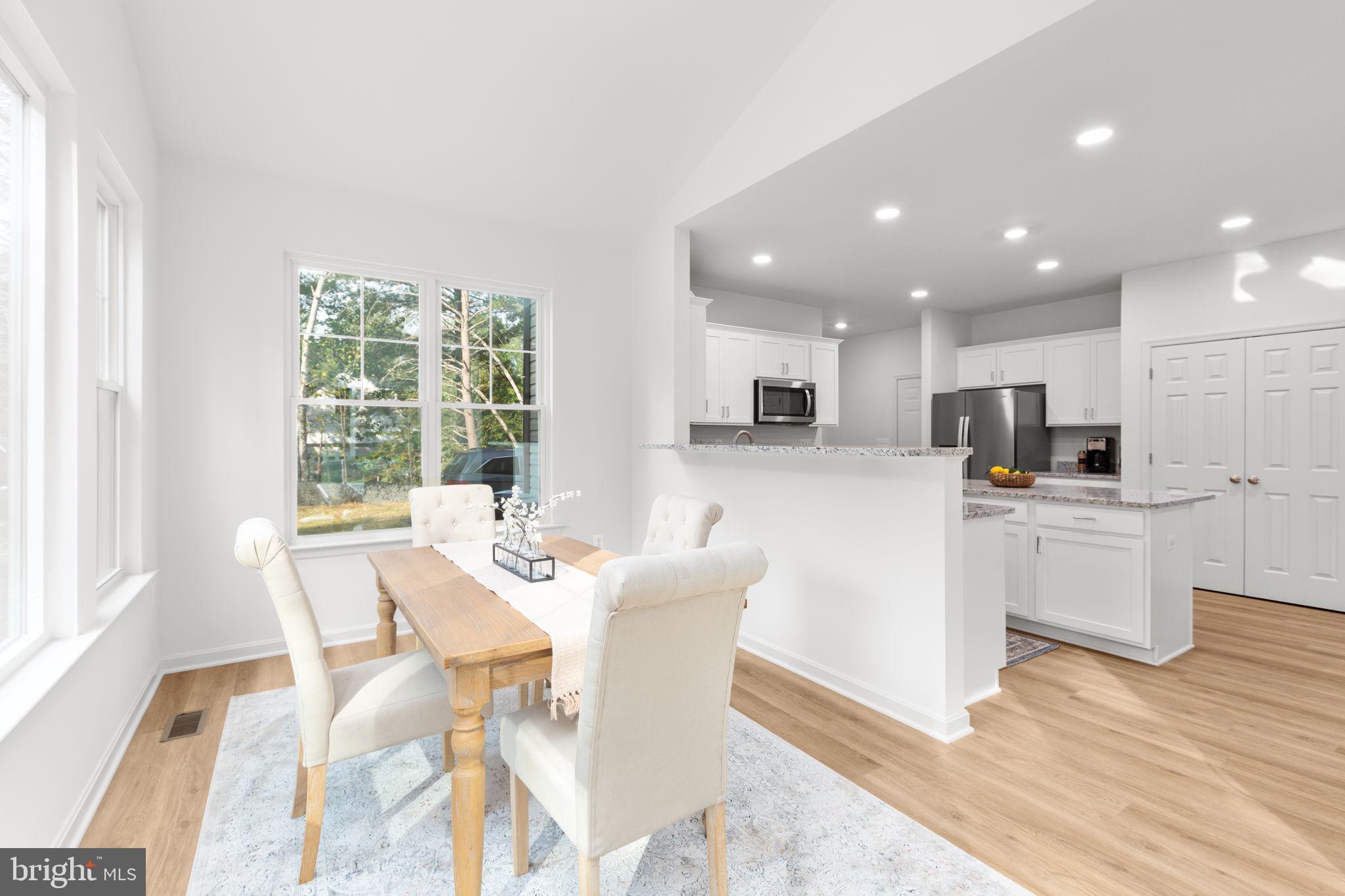 34198 Enchanted Way Locust Grove, VA 22508 - Photo 12 of 62 a view of a dining room with furniture a kitchen and chandelier