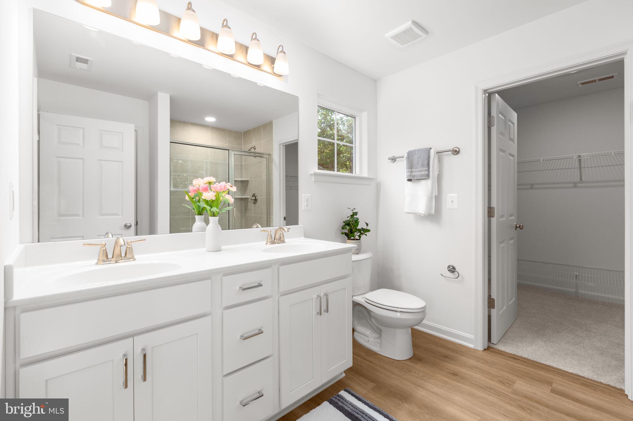 34198 Enchanted Way Locust Grove, VA 22508 - Photo 22 of 62 a bathroom with a double vanity sink toilet and a mirror