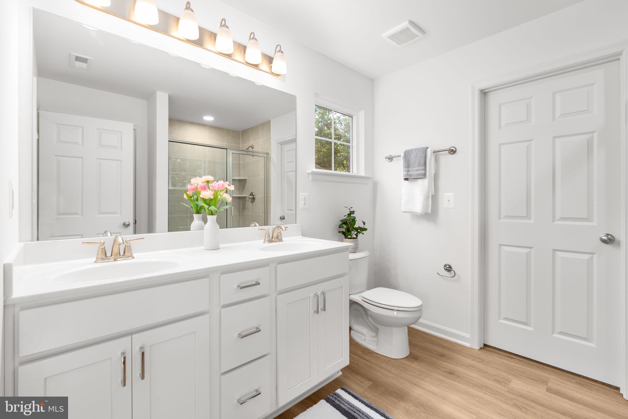 34198 Enchanted Way Locust Grove, VA 22508 - Photo 23 of 62 a bathroom with a double vanity sink toilet and a mirror