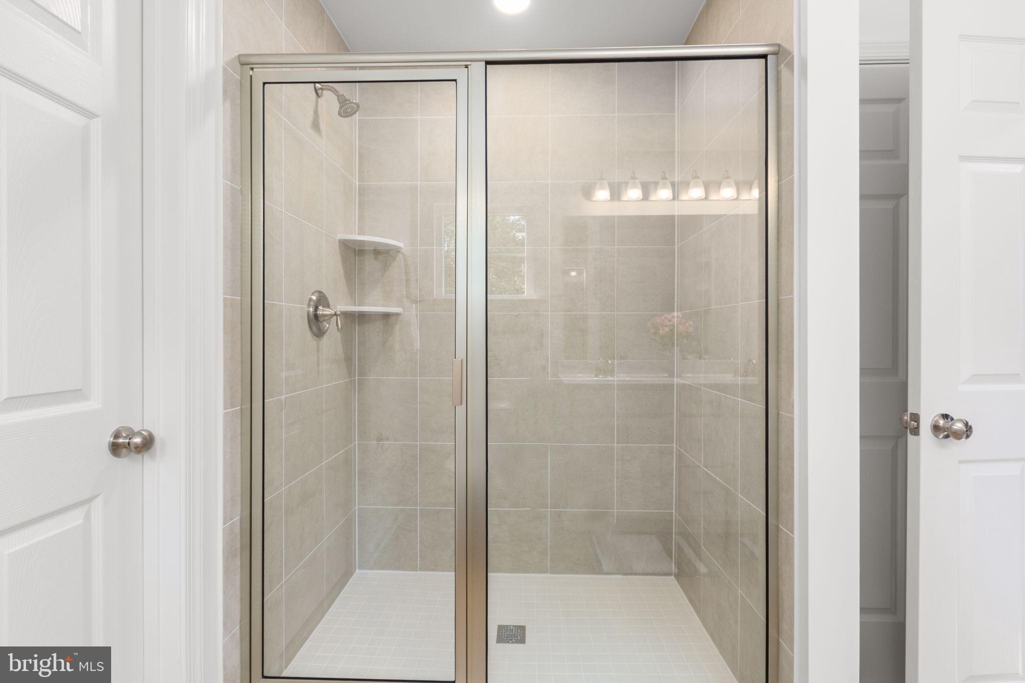 34198 Enchanted Way Locust Grove, VA 22508 - Photo 24 of 62 a bathroom with a glass shower door