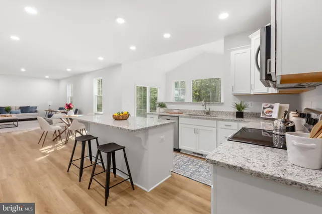 a kitchen with a sink a counter top stainless steel appliances and cabinets