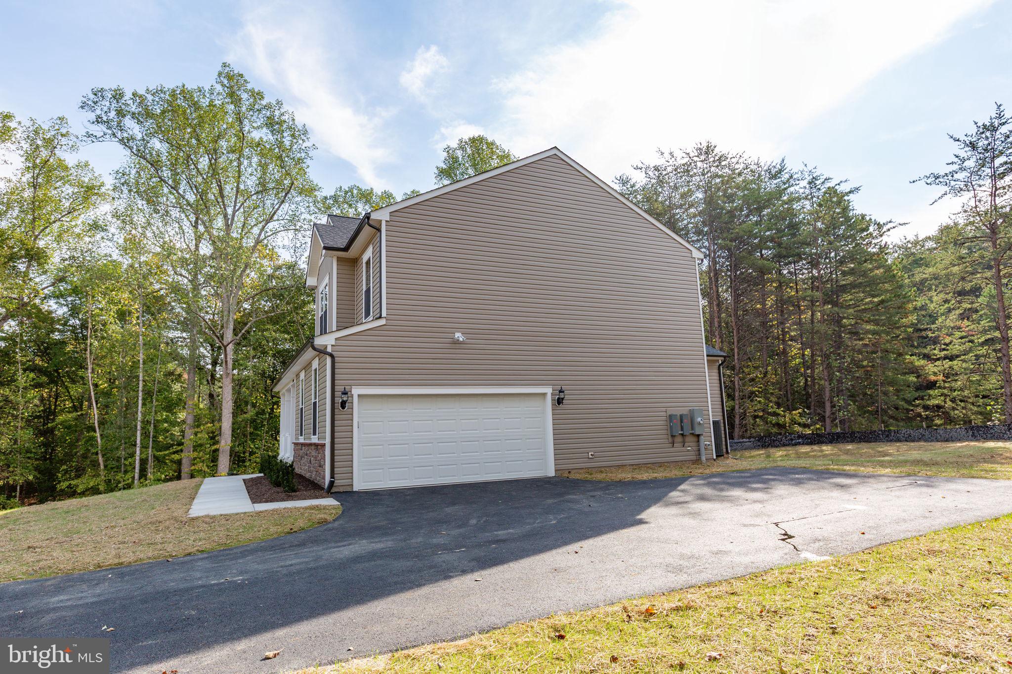 34198 Enchanted Way Locust Grove, VA 22508 - Photo 56 of 62 a view of a house with a yard and garage