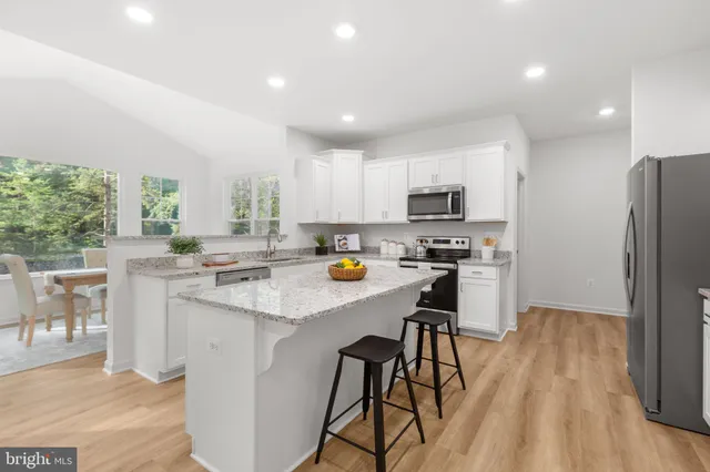 a view of a dining room with furniture kitchen and wooden floor