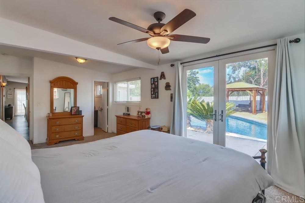 9201 Shadow Hill Road Santee, CA 92071 - Photo 12 of 30 a bedroom with a large bed and a large window