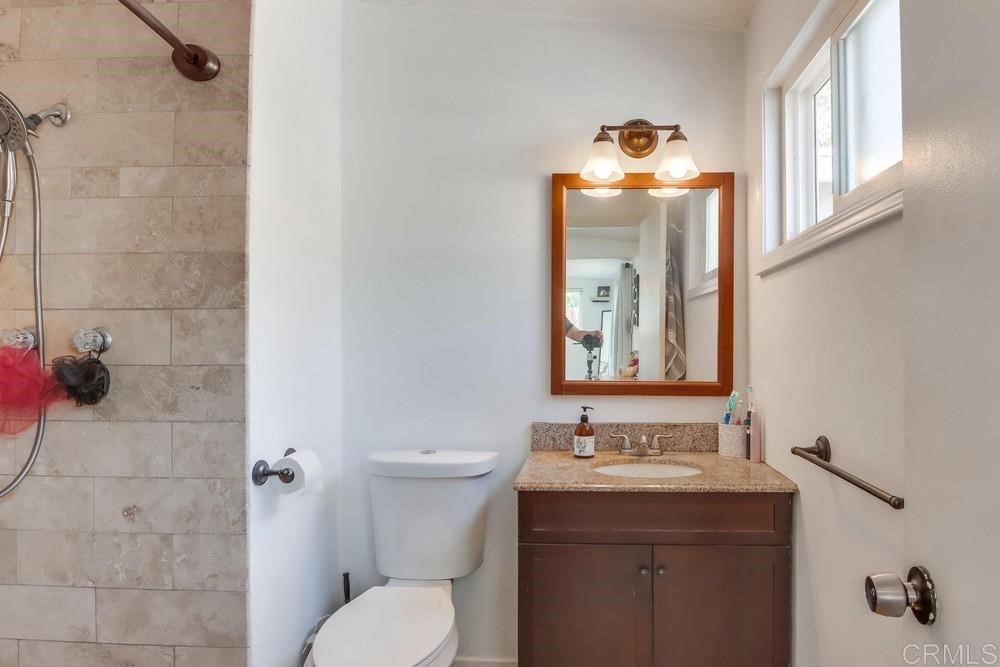 9201 Shadow Hill Road Santee, CA 92071 - Photo 13 of 30 a bathroom with a sink mirror and toilet