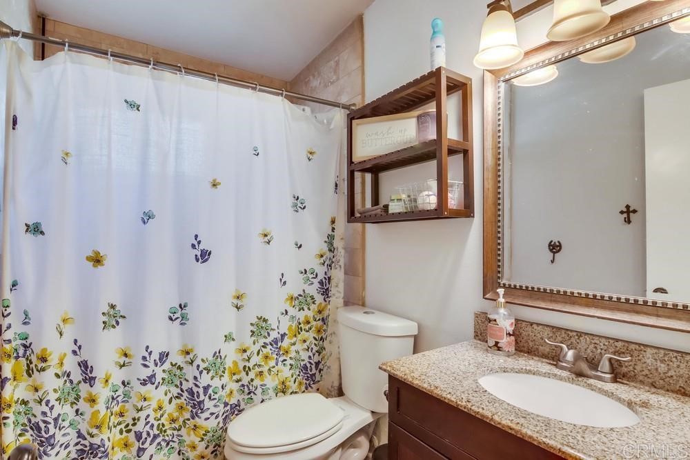 9201 Shadow Hill Road Santee, CA 92071 - Photo 20 of 30 a bathroom with a granite countertop sink toilet and shower