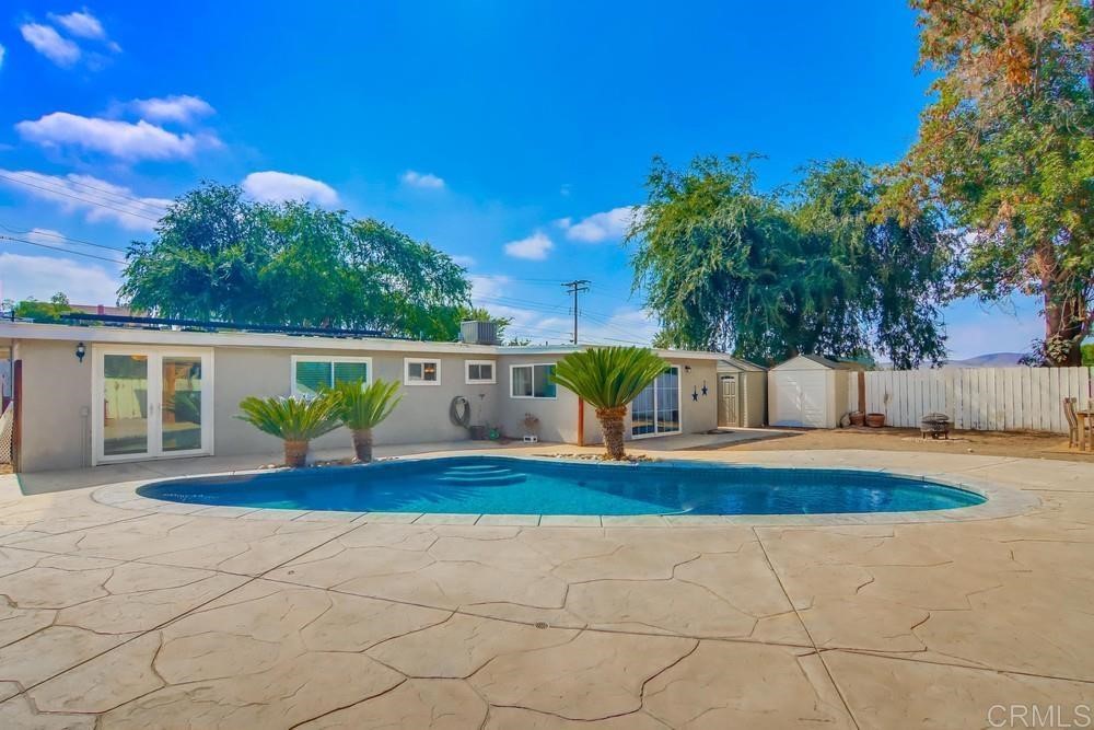 9201 Shadow Hill Road Santee, CA 92071 - Photo 24 of 30 a front view of a house with a yard and garage