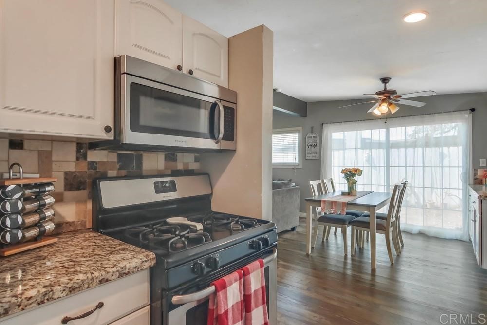 9201 Shadow Hill Road Santee, CA 92071 - Photo 8 of 30 a kitchen with a table chairs and a stove