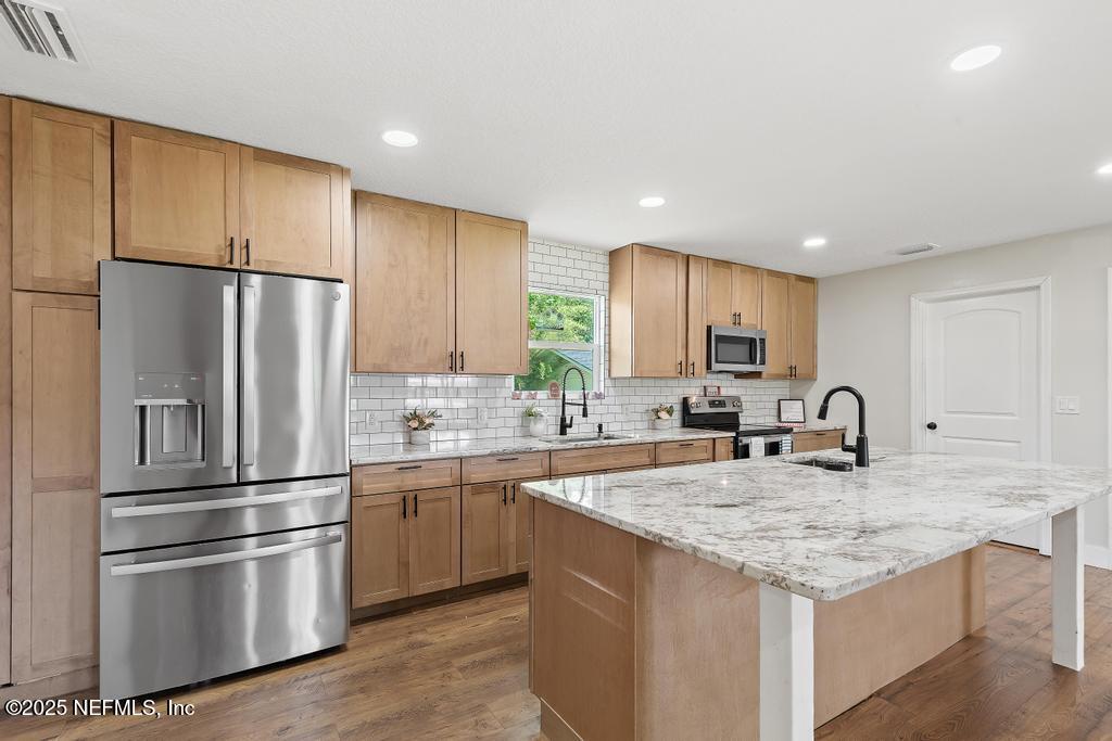 54308 Hurst Road Callahan, FL 32011 - Photo 15 of 49 a kitchen with stainless steel appliances granite countertop a refrigerator a sink and a stove