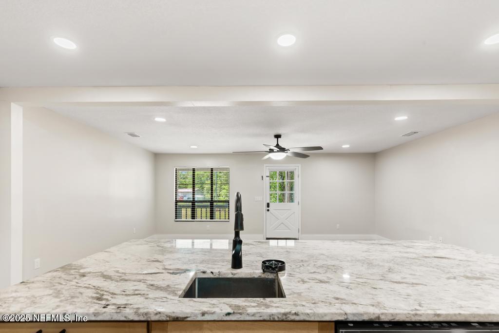 54308 Hurst Road Callahan, FL 32011 - Photo 18 of 49 a view of a kitchen with a sink potted plant and a window