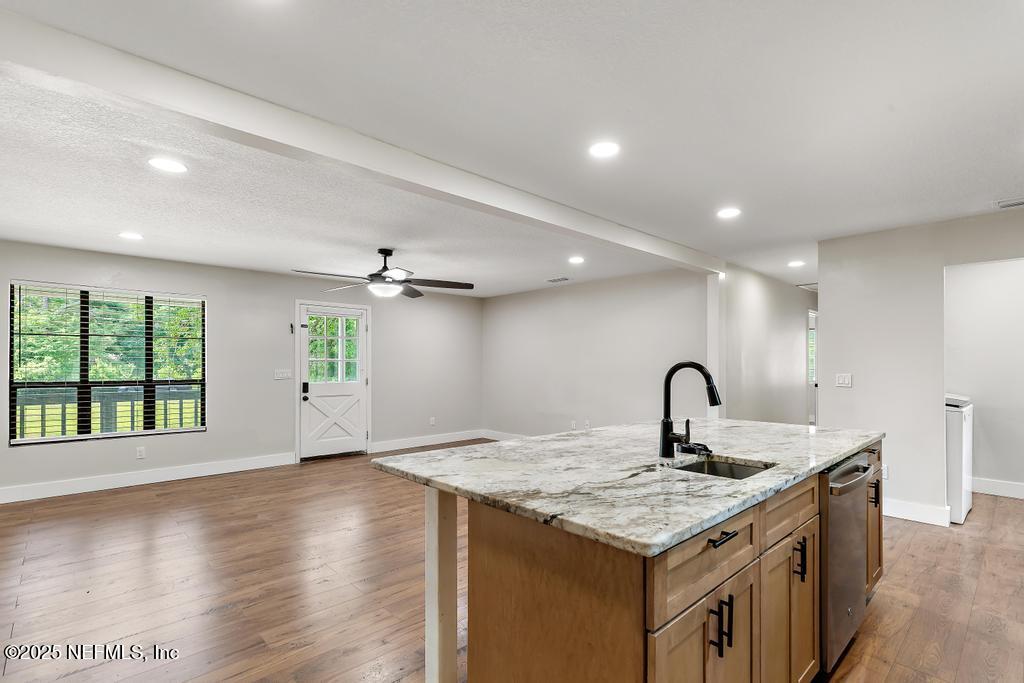 54308 Hurst Road Callahan, FL 32011 - Photo 21 of 49 a kitchen with a stove and a kitchen island with a sink