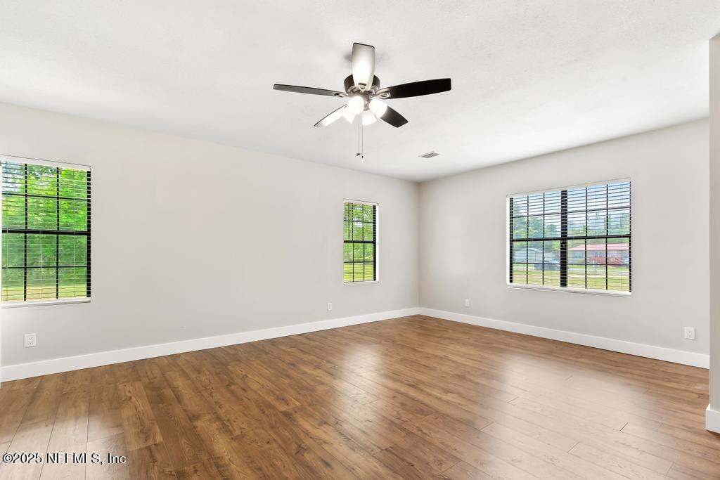 54308 Hurst Road Callahan, FL 32011 - Photo 26 of 49 a view of an empty room with wooden floor and a window