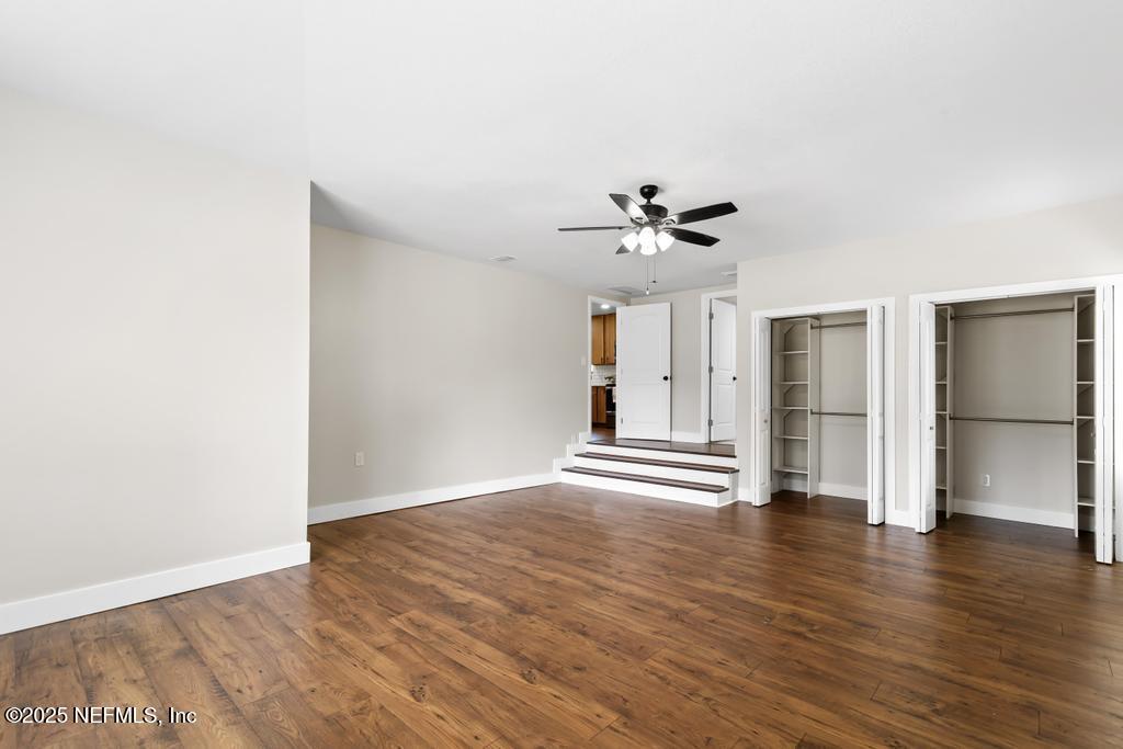 54308 Hurst Road Callahan, FL 32011 - Photo 28 of 49 a view of an empty room with wooden floor and a ceiling fan
