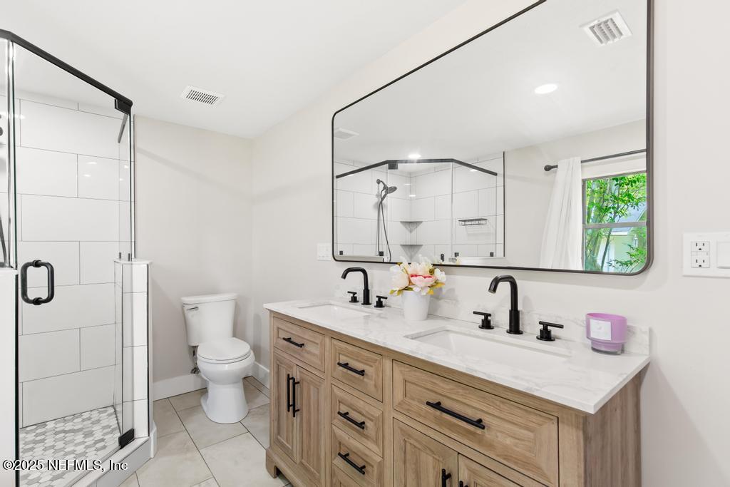 54308 Hurst Road Callahan, FL 32011 - Photo 31 of 49 a bathroom with a double vanity sink mirror and toilet