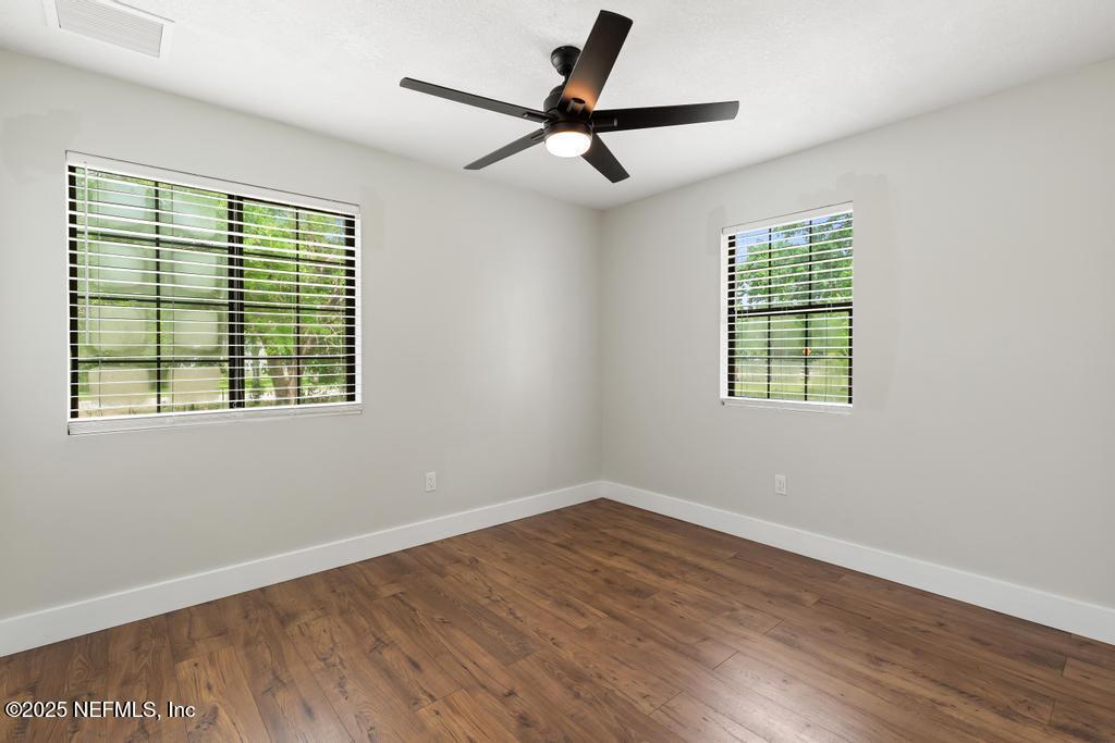 54308 Hurst Road Callahan, FL 32011 - Photo 36 of 49 a view of an empty room with wooden floor and a window