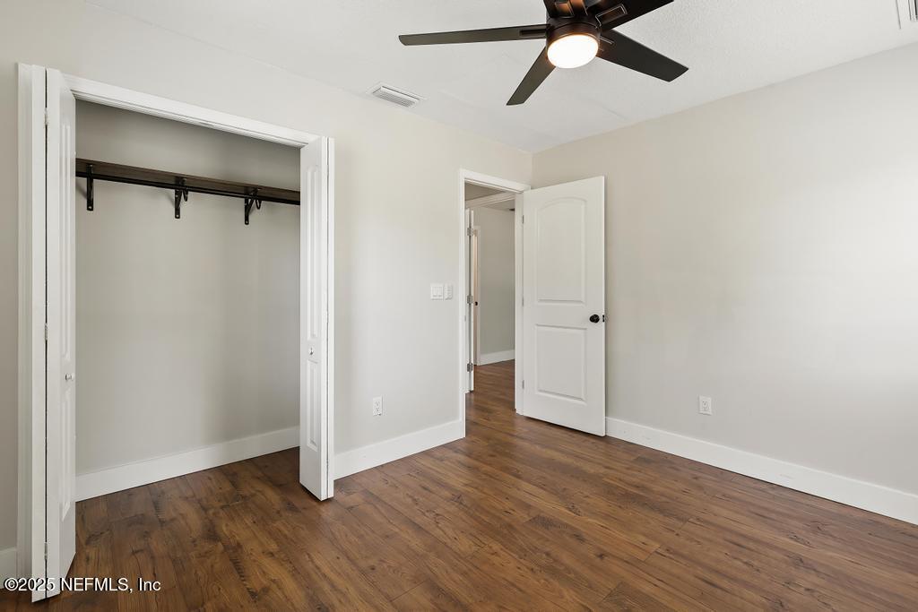 54308 Hurst Road Callahan, FL 32011 - Photo 37 of 49 an empty room with wooden floor a ceiling fan