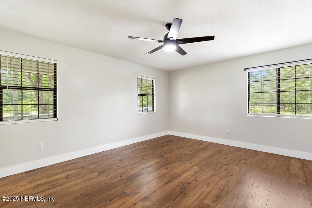 54308 Hurst Road Callahan, FL 32011 - Photo 38 of 49 a view of a big room with wooden floor and windows