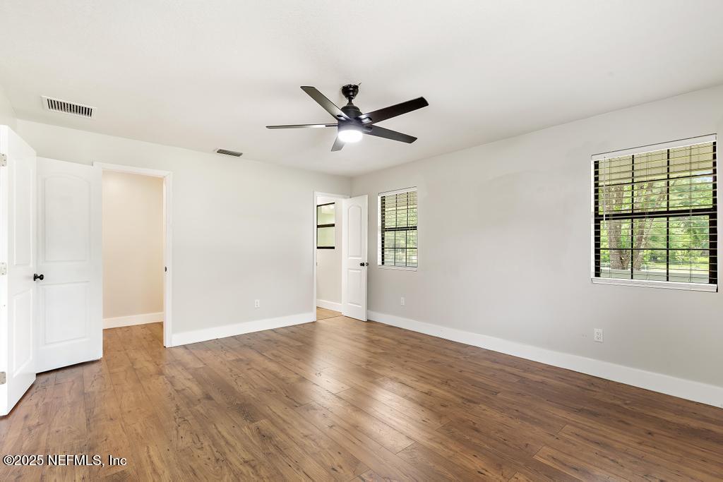 54308 Hurst Road Callahan, FL 32011 - Photo 39 of 49 an empty room with wooden floor and windows