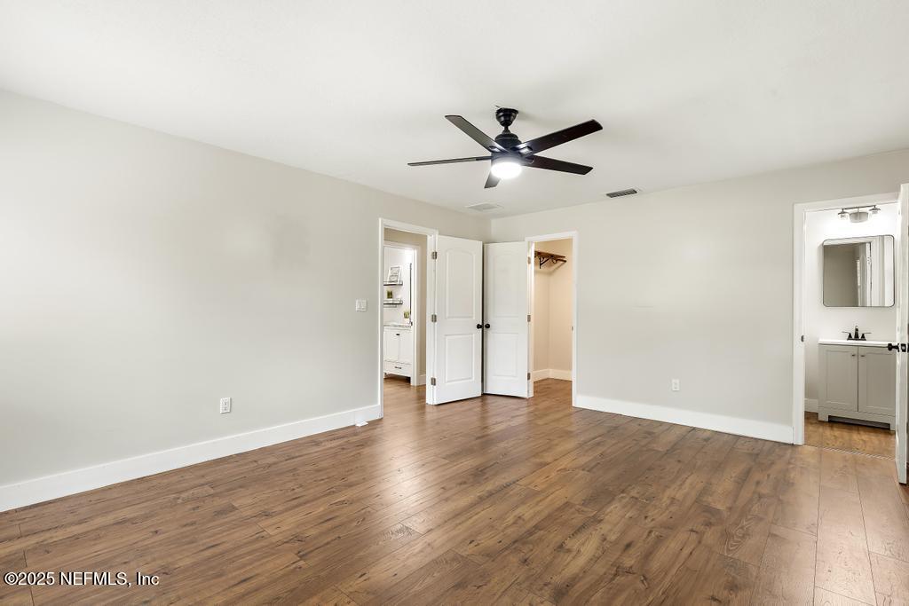 54308 Hurst Road Callahan, FL 32011 - Photo 40 of 49 a view of an empty room with wooden floor and a ceiling fan
