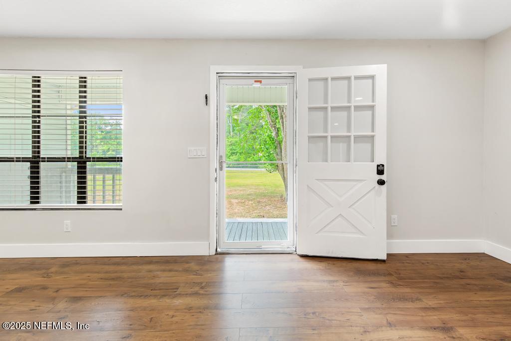 54308 Hurst Road Callahan, FL 32011 - Photo 8 of 49 a view of an empty room with wooden floor and a window