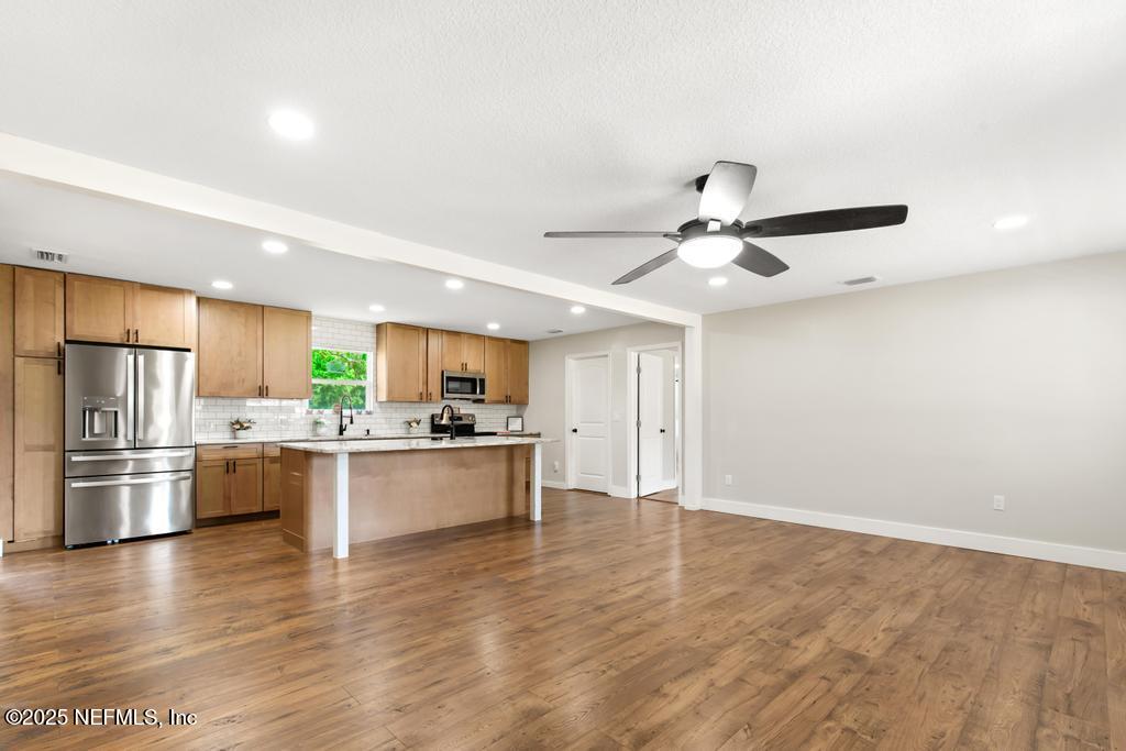 54308 Hurst Road Callahan, FL 32011 - Photo 9 of 49 a kitchen with stainless steel appliances wooden floor and a refrigerator