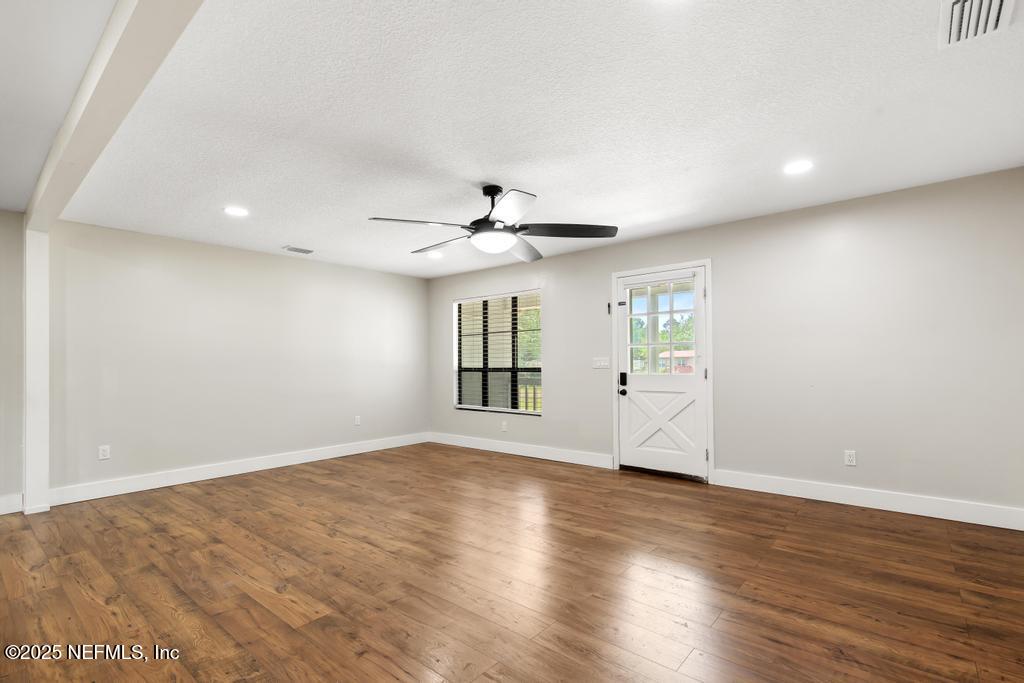 54308 Hurst Road Callahan, FL 32011 - Photo 10 of 49 a view of an empty room with wooden floor and a window