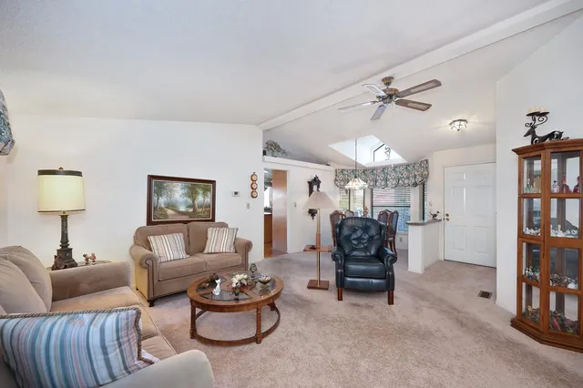a view of a dining room with furniture wooden floor and a chandelier