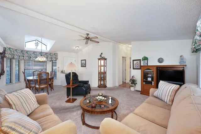 a view of a dining room with furniture wooden floor and chandelier