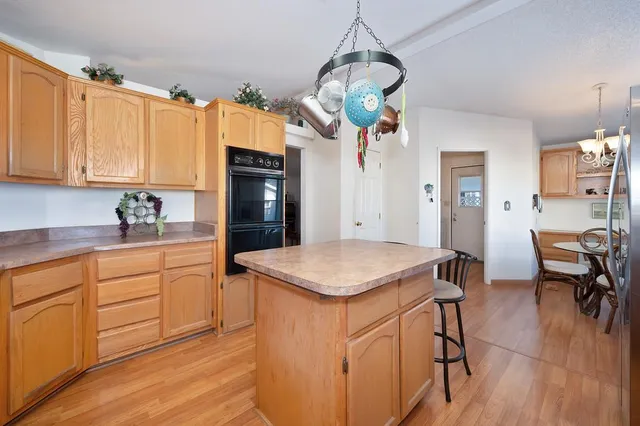 a living room with blue lights with furniture and a fireplace