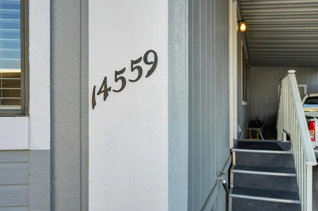 a dining room with furniture a chandelier and wooden floor
