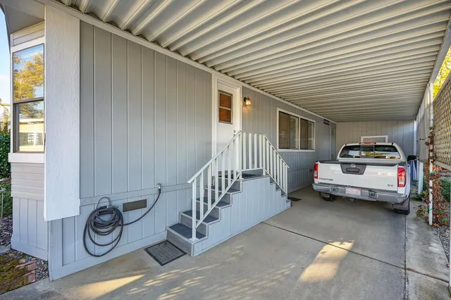 a view of a dining room with furniture and a chandelier