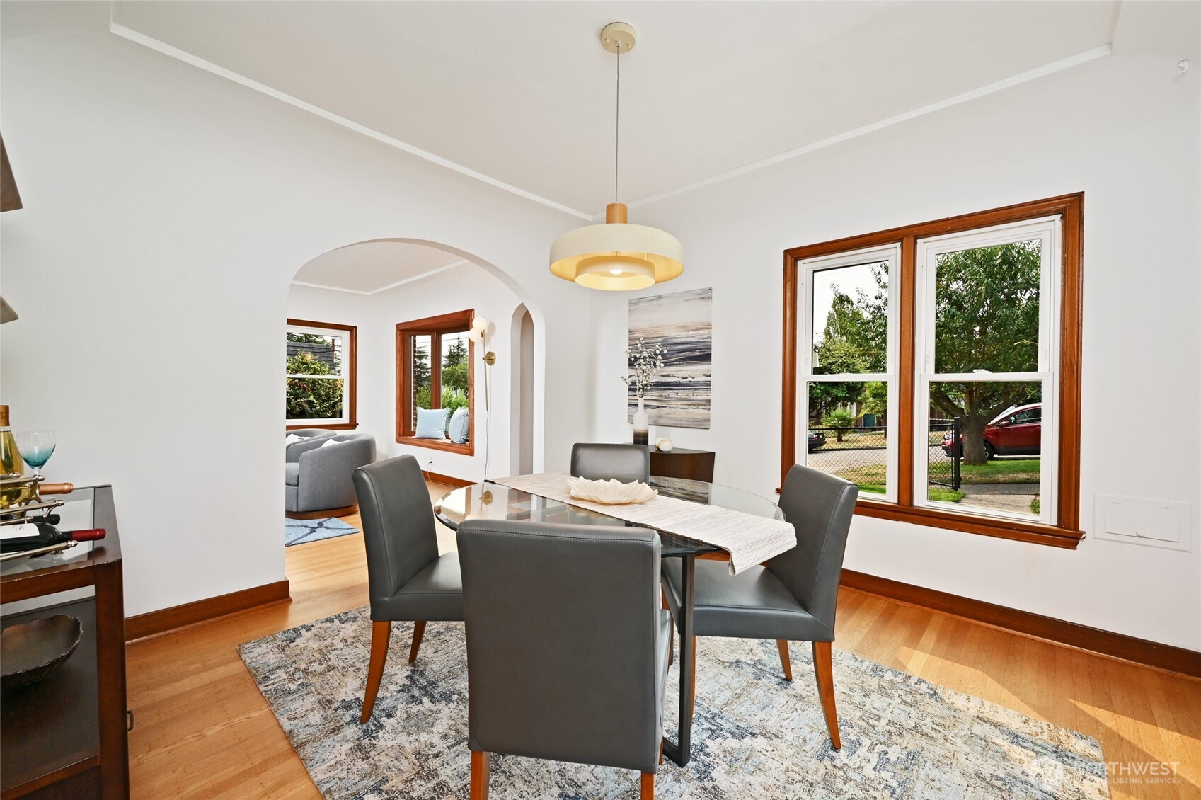 334 Northeast 57th Street Seattle, WA 98105 - Photo 12 of 39 a dining room with furniture a chandelier and wooden floor