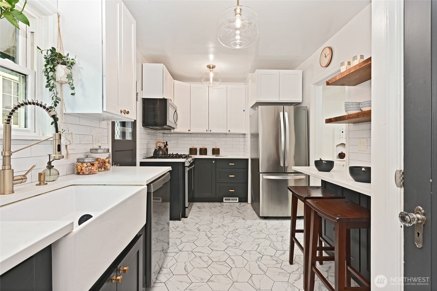 334 Northeast 57th Street Seattle, WA 98105 - Photo 13 of 39 a kitchen with a sink appliances and cabinets