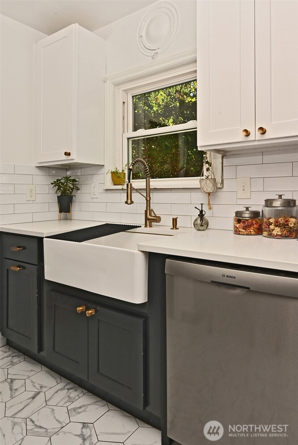 334 Northeast 57th Street Seattle, WA 98105 - Photo 14 of 39 a kitchen with a sink window and cabinets