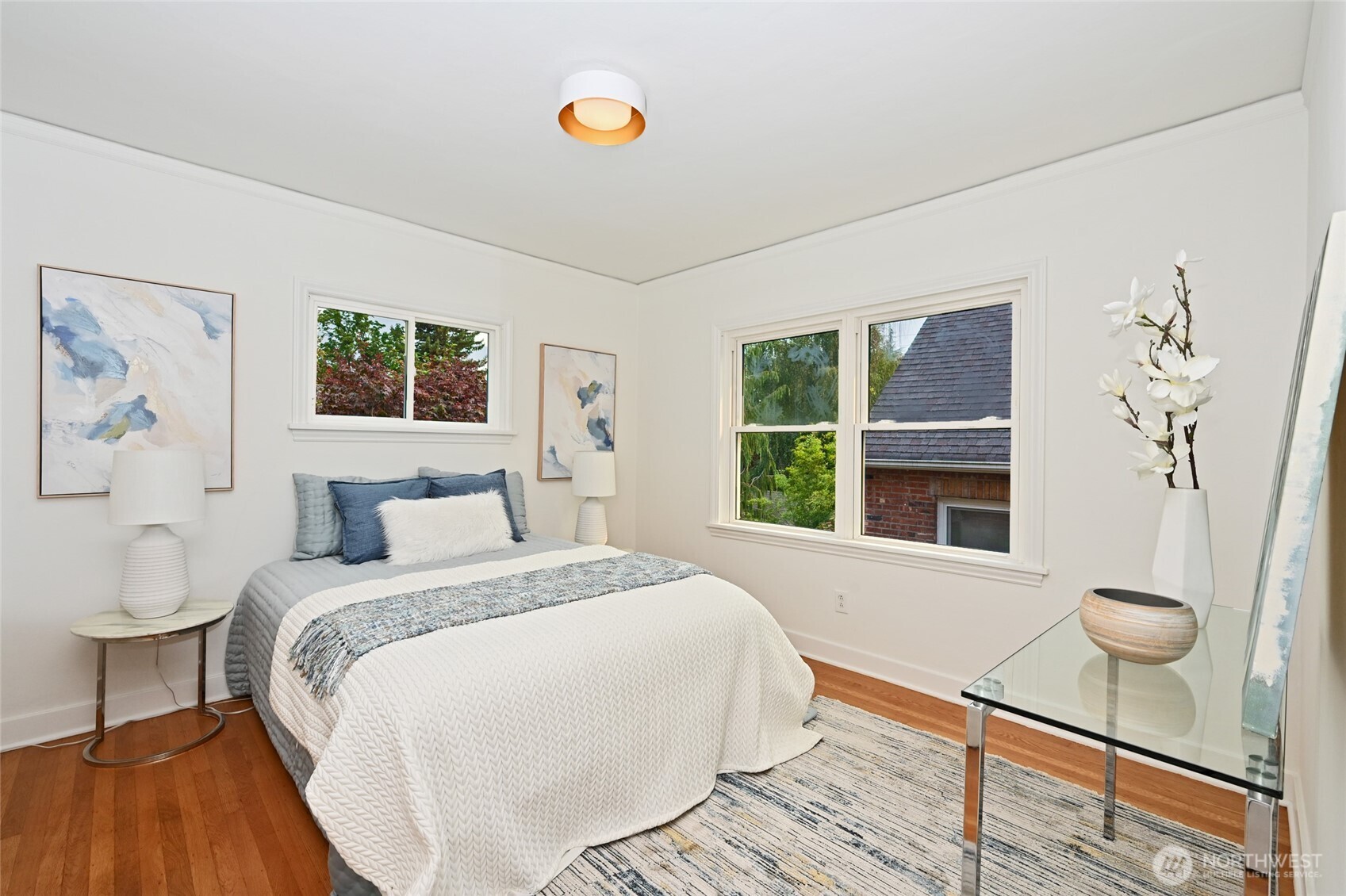 334 Northeast 57th Street Seattle, WA 98105 - Photo 16 of 39 a bedroom with a bed and a large window with wooden floor
