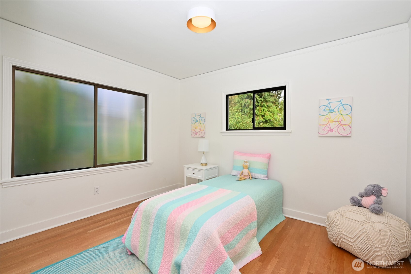 334 Northeast 57th Street Seattle, WA 98105 - Photo 17 of 39 a bedroom with a bed and a window