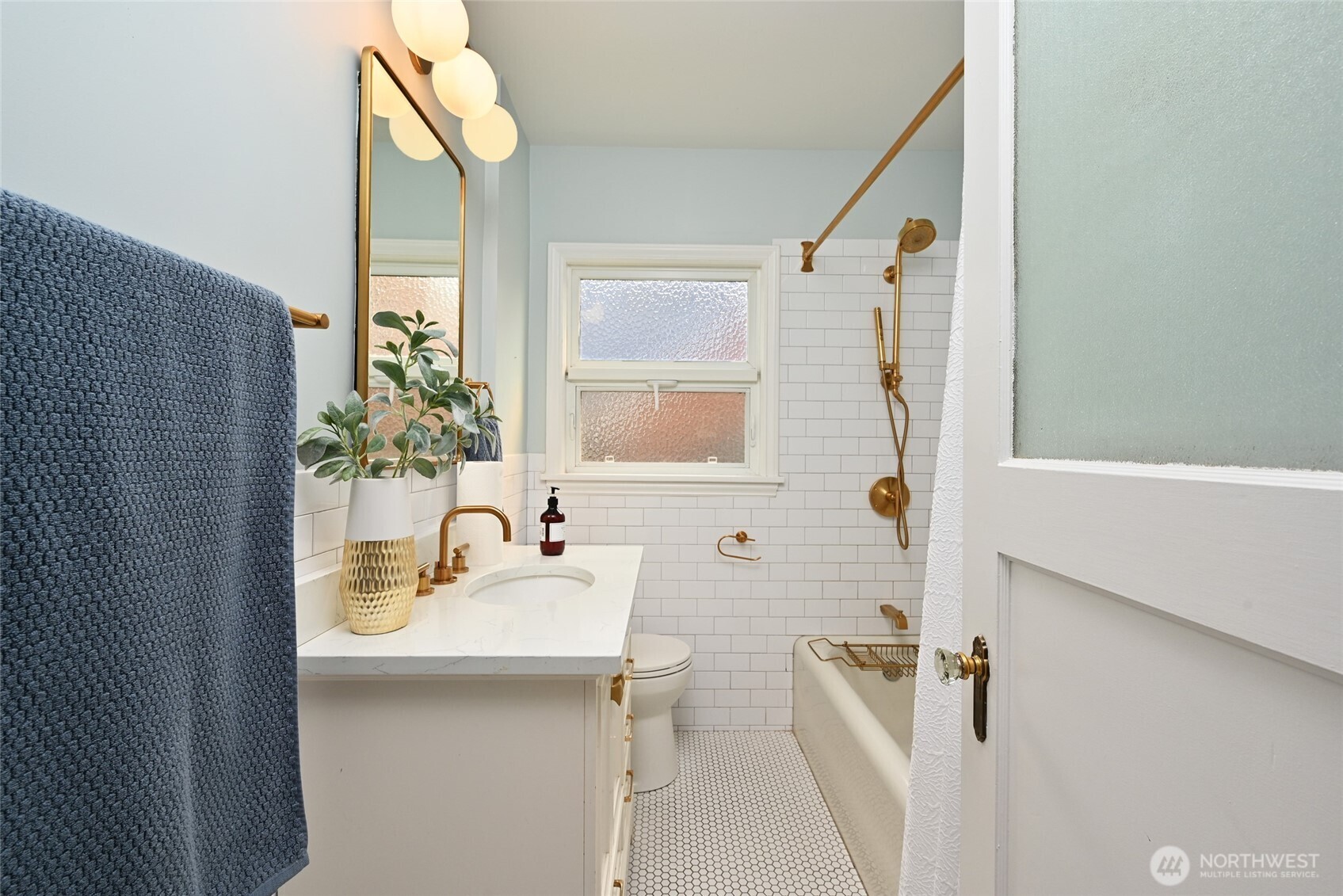334 Northeast 57th Street Seattle, WA 98105 - Photo 18 of 39 a bathroom with a sink a tub and a mirror