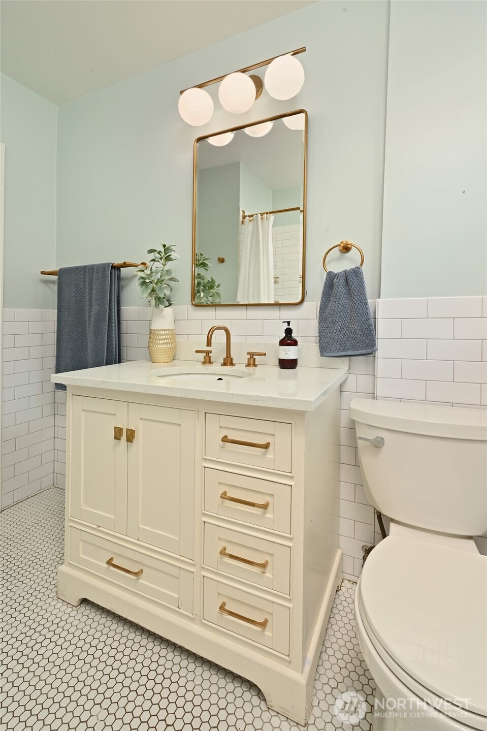 334 Northeast 57th Street Seattle, WA 98105 - Photo 19 of 39 a bathroom with a sink a toilet and mirror
