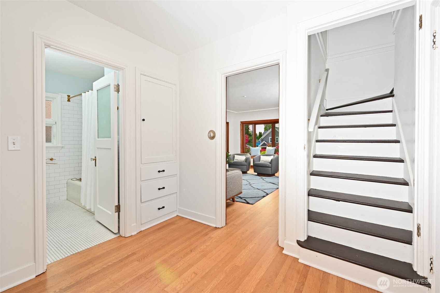 334 Northeast 57th Street Seattle, WA 98105 - Photo 21 of 39 a bedroom with a bed and wooden floor