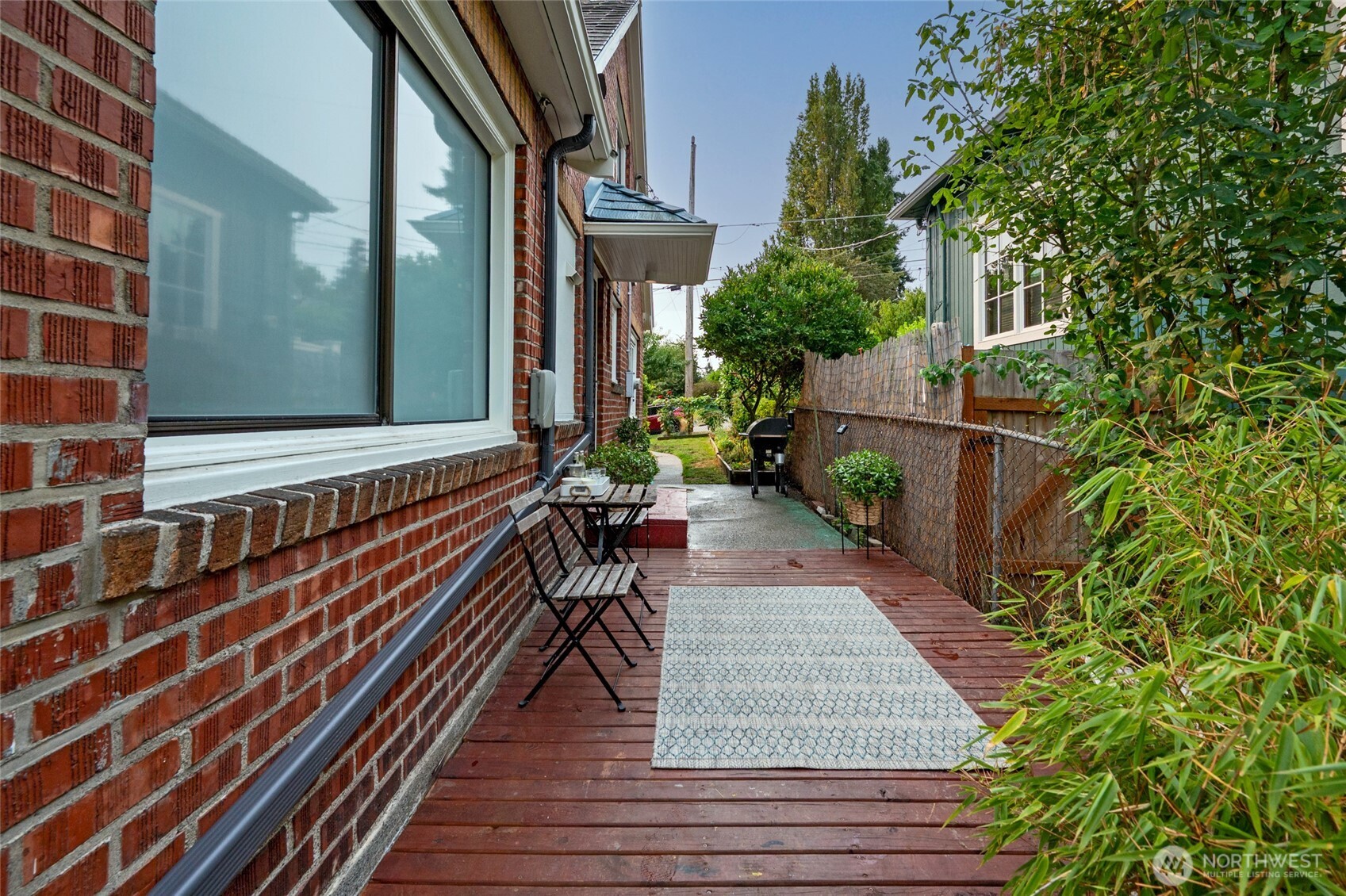 334 Northeast 57th Street Seattle, WA 98105 - Photo 33 of 39 a backyard of a house with wooden floor and outdoor seating